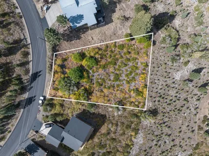 an aerial view of a house with a yard