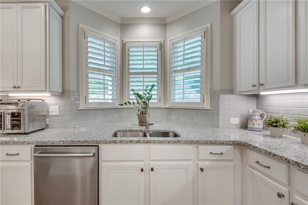 3315 Thimbleberry Trail Dacula, GA 30019 - Photo 19 of 59 a kitchen with granite countertop stainless steel appliances window sink and cabinets