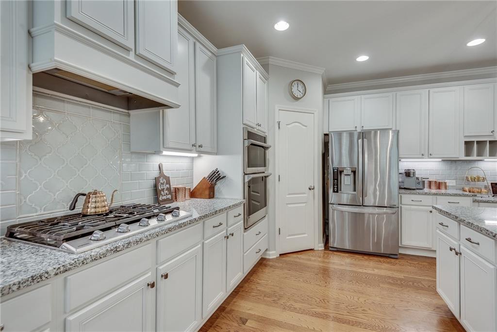 3315 Thimbleberry Trail Dacula, GA 30019 - Photo 20 of 59 a kitchen with stainless steel appliances granite countertop a refrigerator and a stove top oven