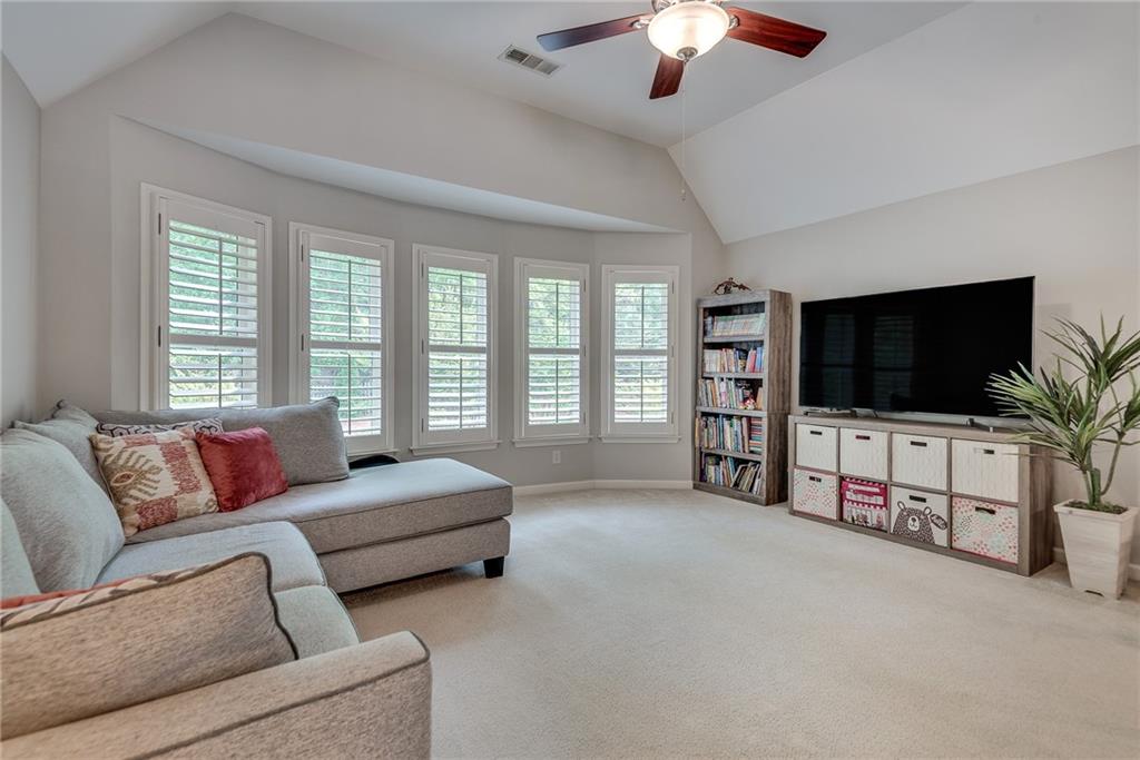 3315 Thimbleberry Trail Dacula, GA 30019 - Photo 28 of 59 a living room with furniture and a flat screen tv