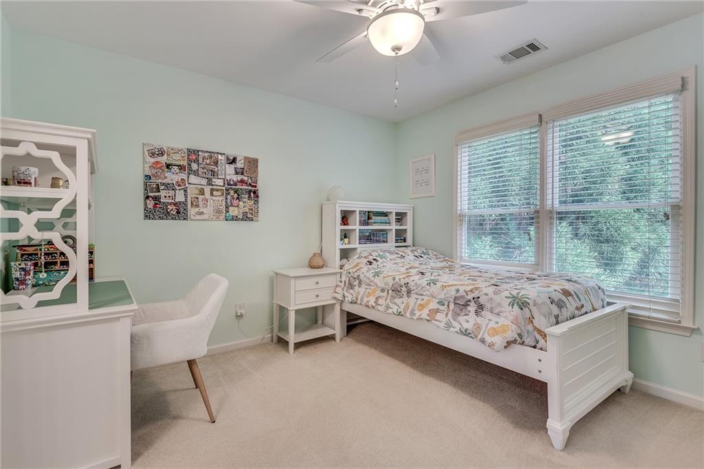 3315 Thimbleberry Trail Dacula, GA 30019 - Photo 33 of 59 a bedroom with a bed chair and window