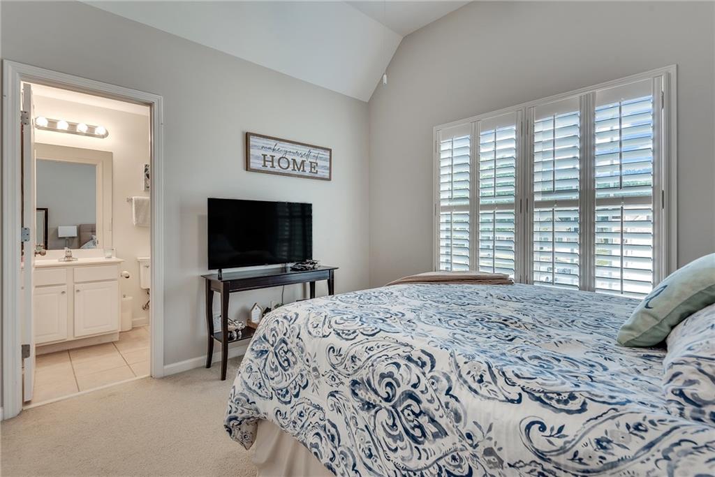 3315 Thimbleberry Trail Dacula, GA 30019 - Photo 37 of 59 a bedroom with a bed and a flat screen tv