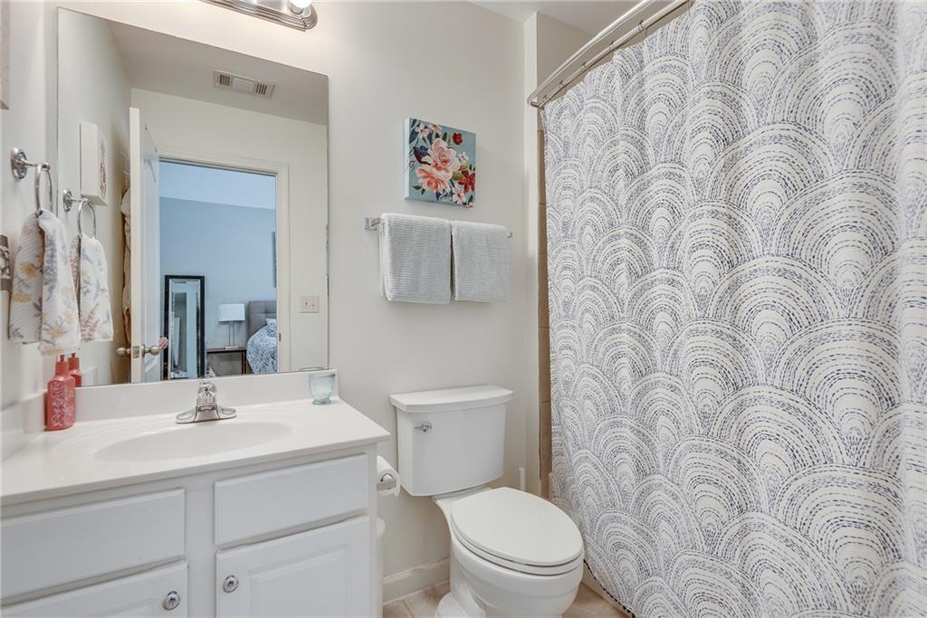 3315 Thimbleberry Trail Dacula, GA 30019 - Photo 38 of 59 a bathroom with a toilet a sink and a mirror
