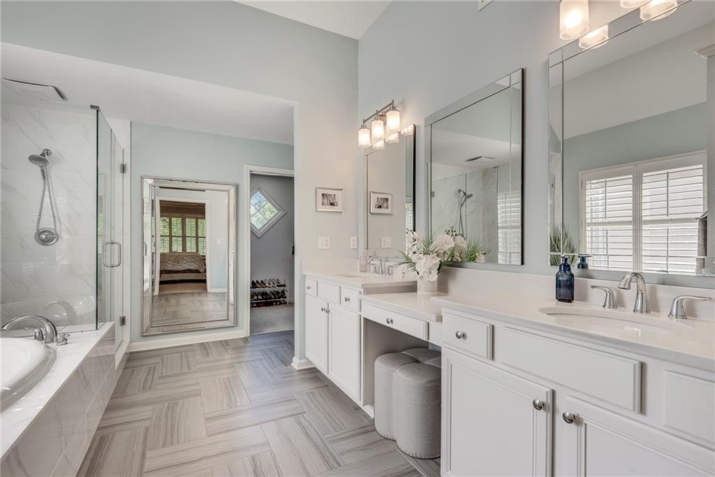 3315 Thimbleberry Trail Dacula, GA 30019 - Photo 41 of 59 a spacious bathroom with a double vanity sink a large mirror and a bathtub