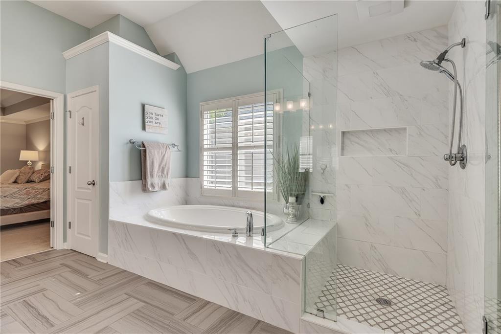3315 Thimbleberry Trail Dacula, GA 30019 - Photo 44 of 59 a spacious bathroom with a tub a sink and a shower