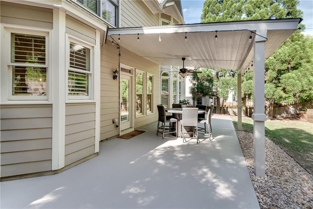 3315 Thimbleberry Trail Dacula, GA 30019 - Photo 46 of 59 a view of a patio with table and chairs and potted plants