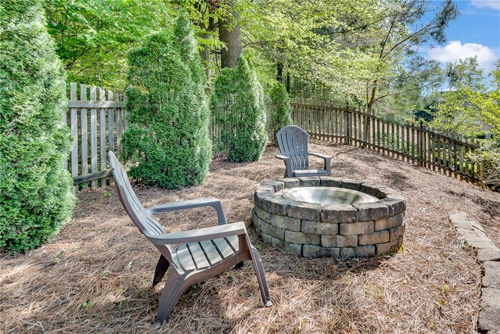3315 Thimbleberry Trail Dacula, GA 30019 - Photo 50 of 59 a view of a chair and table in backyard