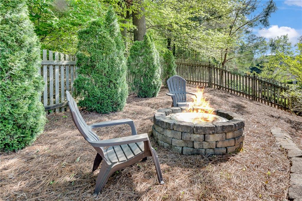 3315 Thimbleberry Trail Dacula, GA 30019 - Photo 51 of 59 a view of an outdoor sitting area with brick wall