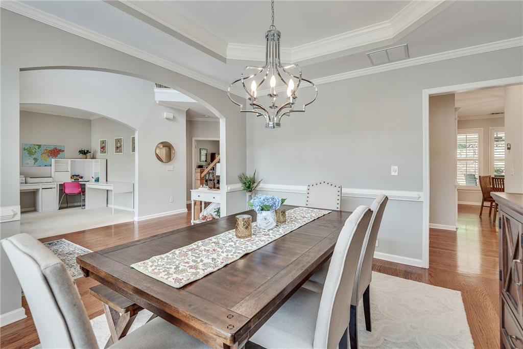 3315 Thimbleberry Trail Dacula, GA 30019 - Photo 9 of 59 a view of a dining room with furniture and a chandelier