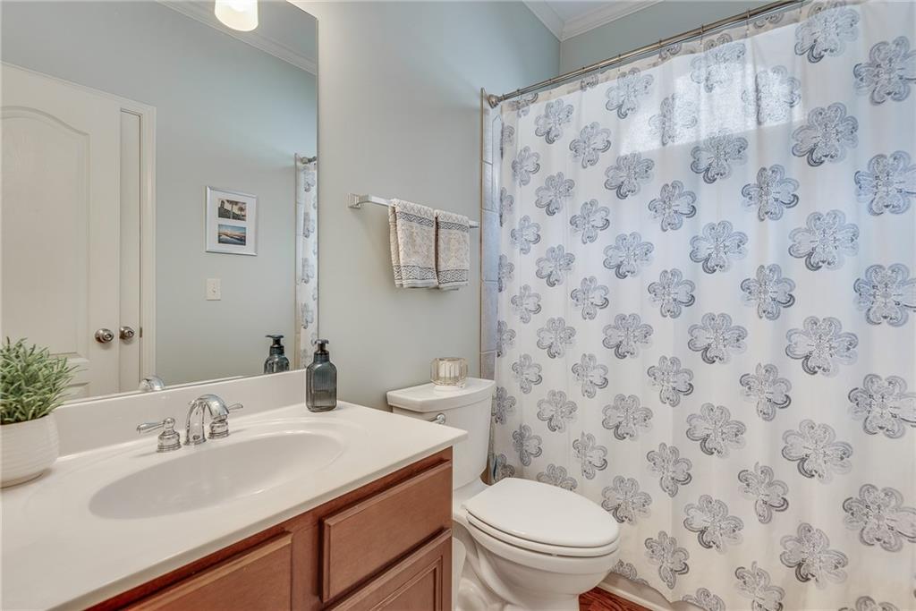 3315 Thimbleberry Trail Dacula, GA 30019 - Photo 10 of 59 a bathroom with a sink toilet and mirror
