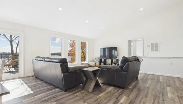 a living room with furniture and a wooden floor