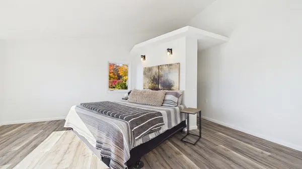 a spacious bedroom with a large bed and a large window