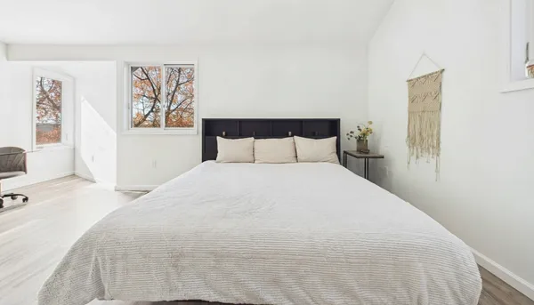 a bedroom with a bed and a night stand