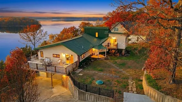 a view of a balcony with wooden floor and fence
