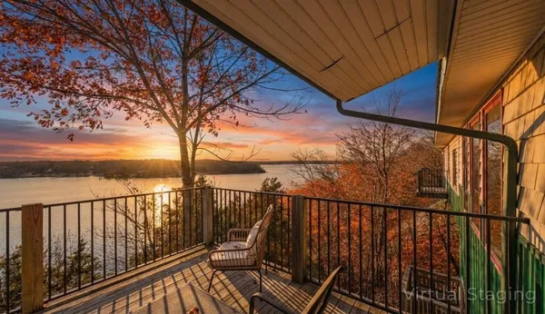 a view of a balcony with wooden chairs and floor to ceiling window