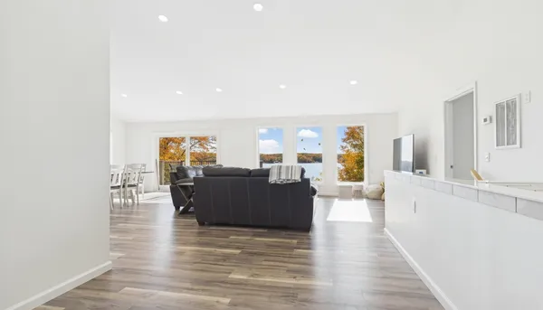 a view of a dining room with furniture and a large window