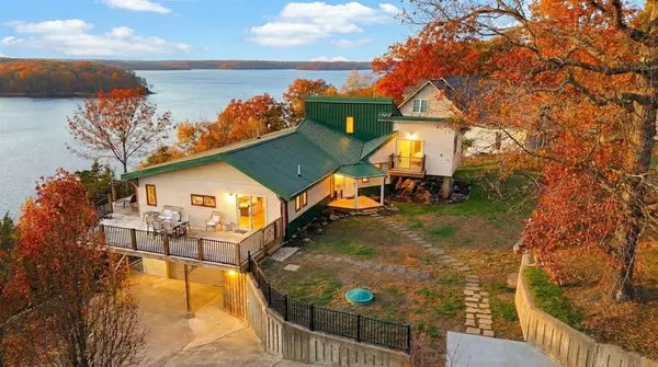 a view of a dining room with furniture a chandelier and wooden floor