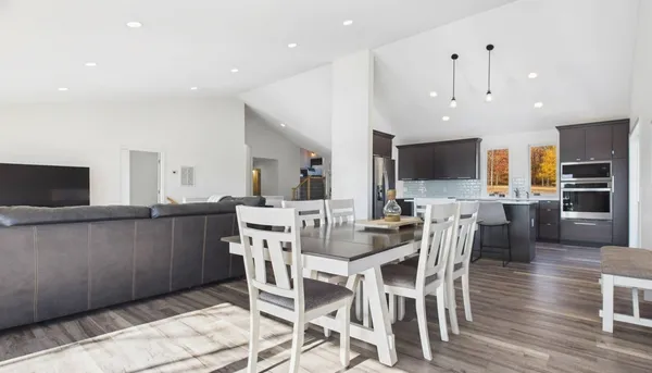 a view of a dining room with furniture and wooden floor