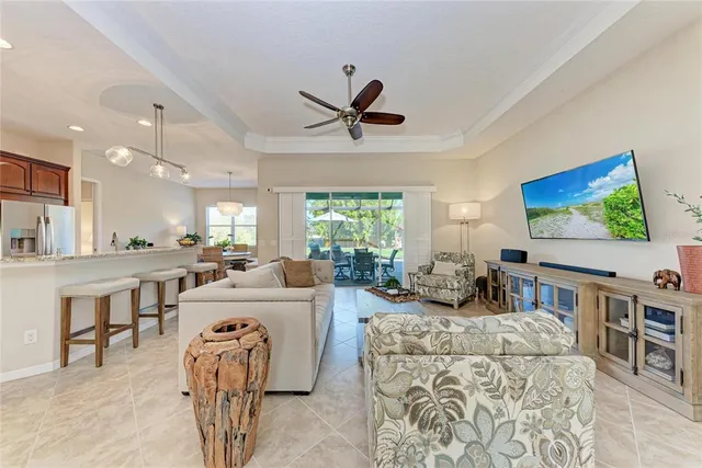a living room with furniture a window and a flat screen tv