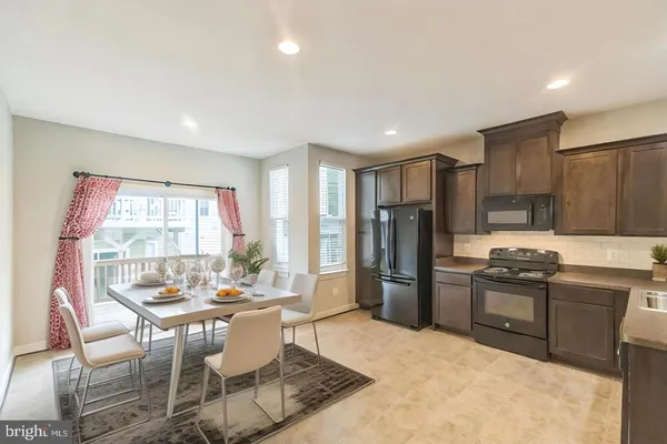 a kitchen with stainless steel appliances granite countertop a refrigerator stove and sink