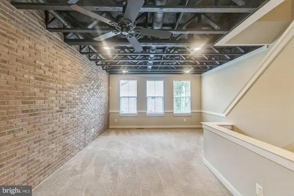 a front view of a building with a tree