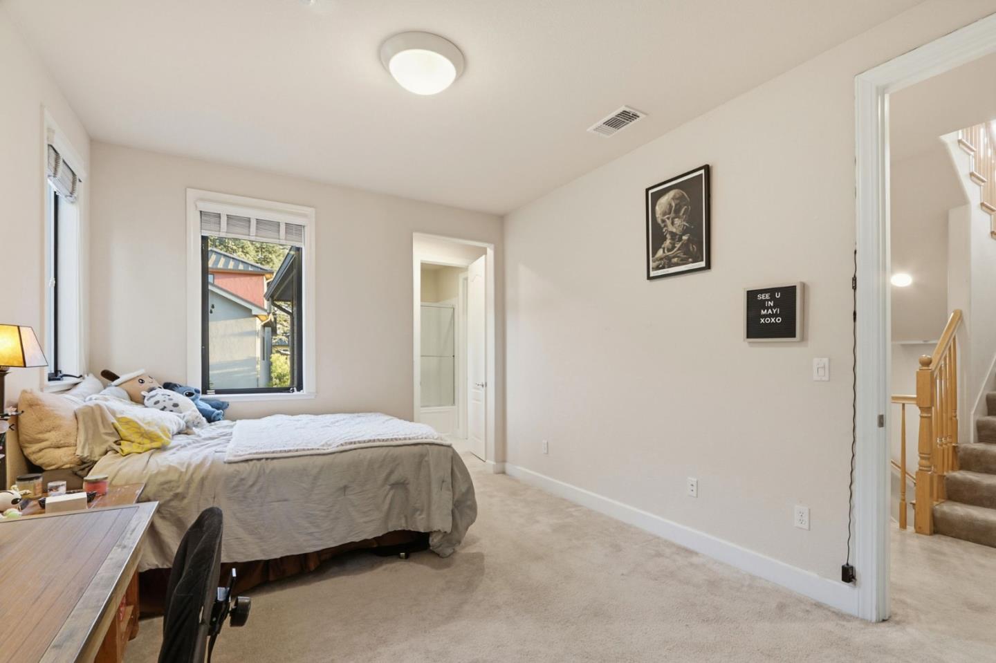 409 Spruce Lane Palo Alto, CA 94306 - Photo 30 of 52 a bedroom with bed and windows