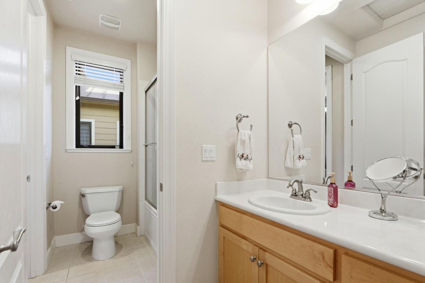 409 Spruce Lane Palo Alto, CA 94306 - Photo 34 of 52 a bathroom with a toilet a sink and mirror