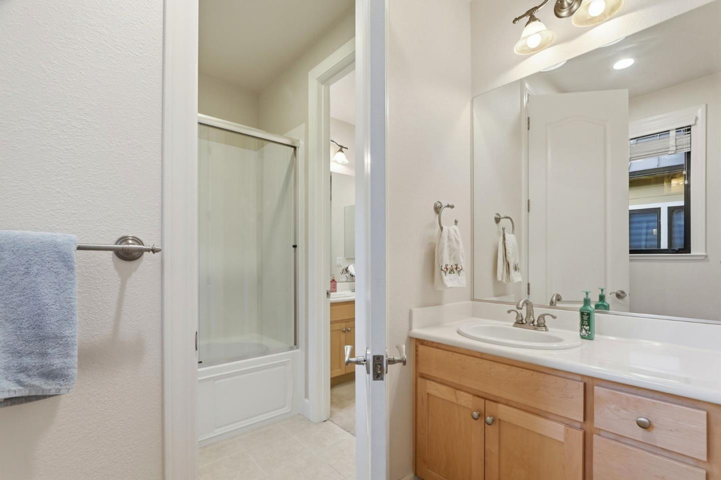 409 Spruce Lane Palo Alto, CA 94306 - Photo 35 of 52 a bathroom with a shower sink vanity and mirror