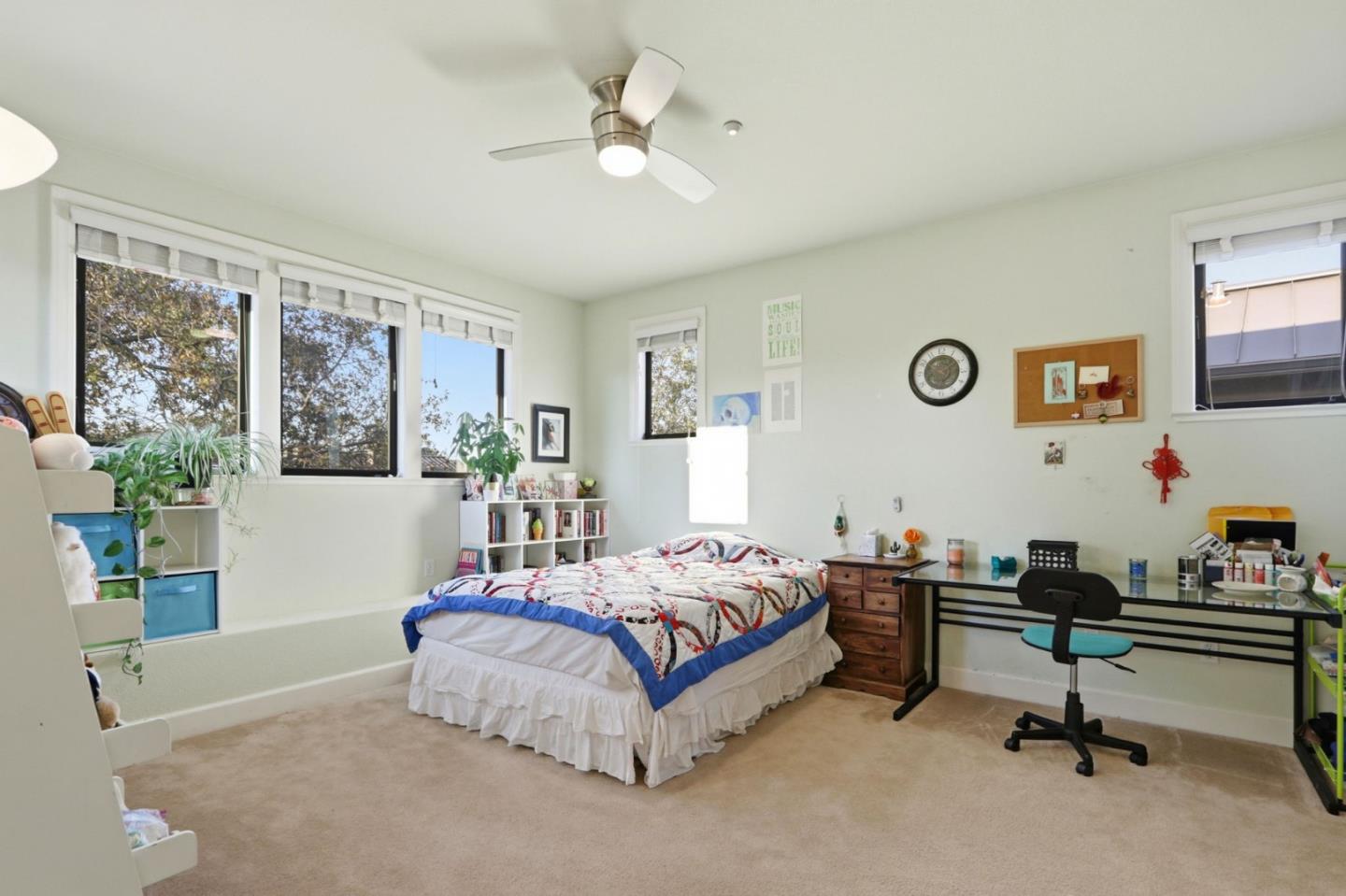409 Spruce Lane Palo Alto, CA 94306 - Photo 38 of 52 a bedroom with a bed a couch and a window