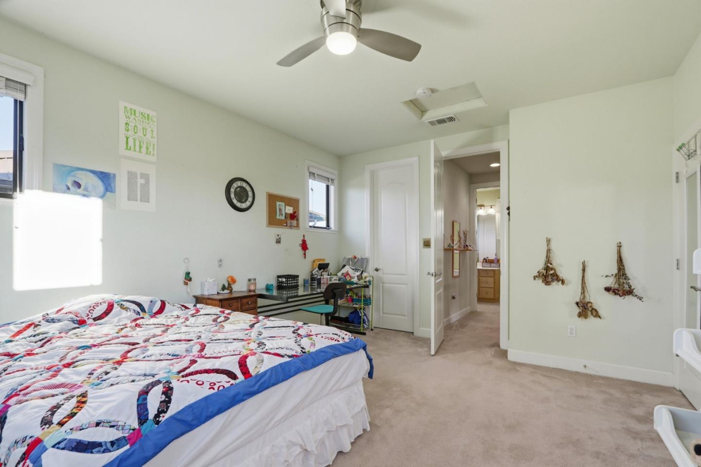 409 Spruce Lane Palo Alto, CA 94306 - Photo 39 of 52 a bedroom with a bed and a chandelier