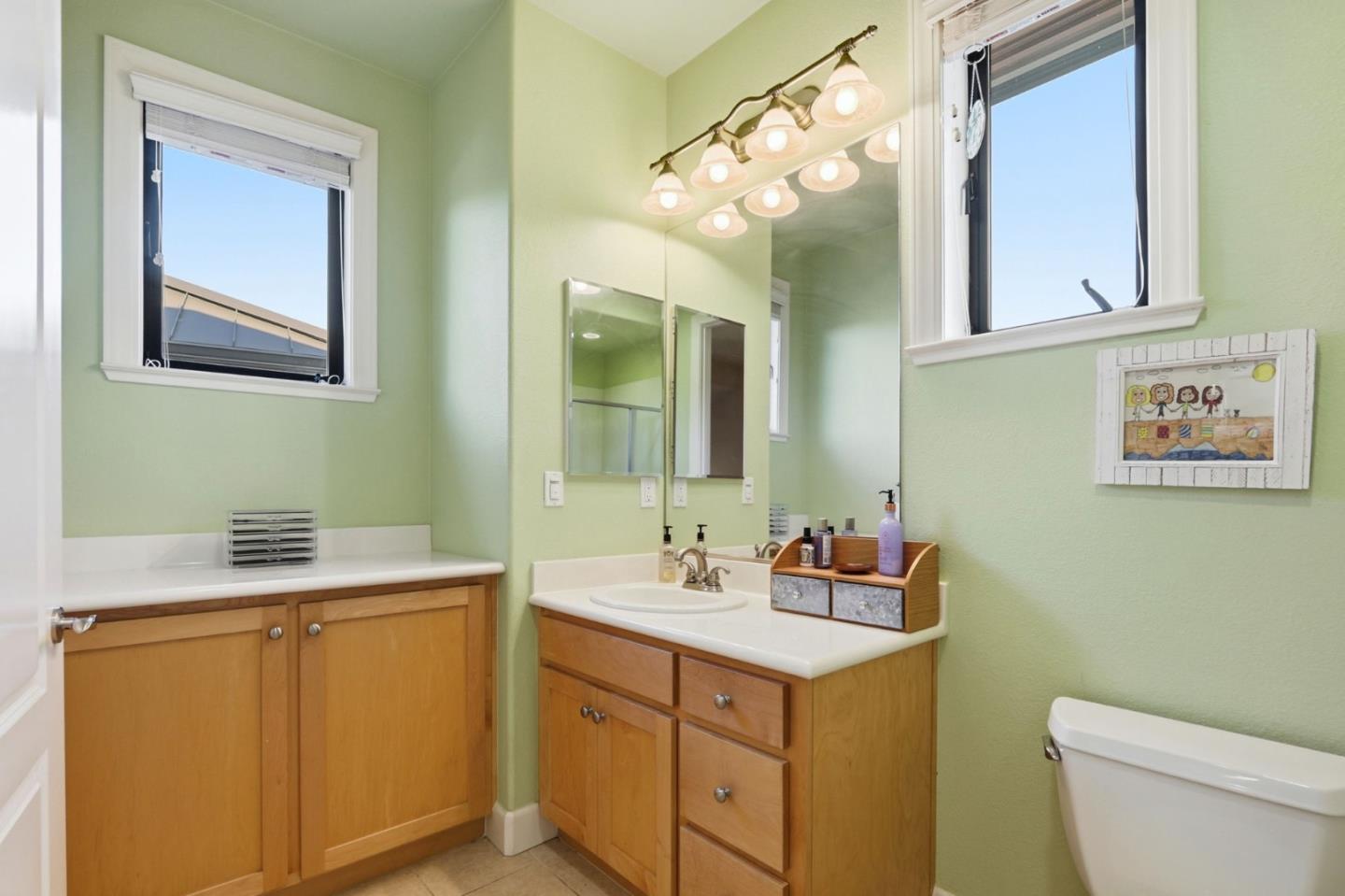 409 Spruce Lane Palo Alto, CA 94306 - Photo 42 of 52 a bathroom with a toilet sink and mirror