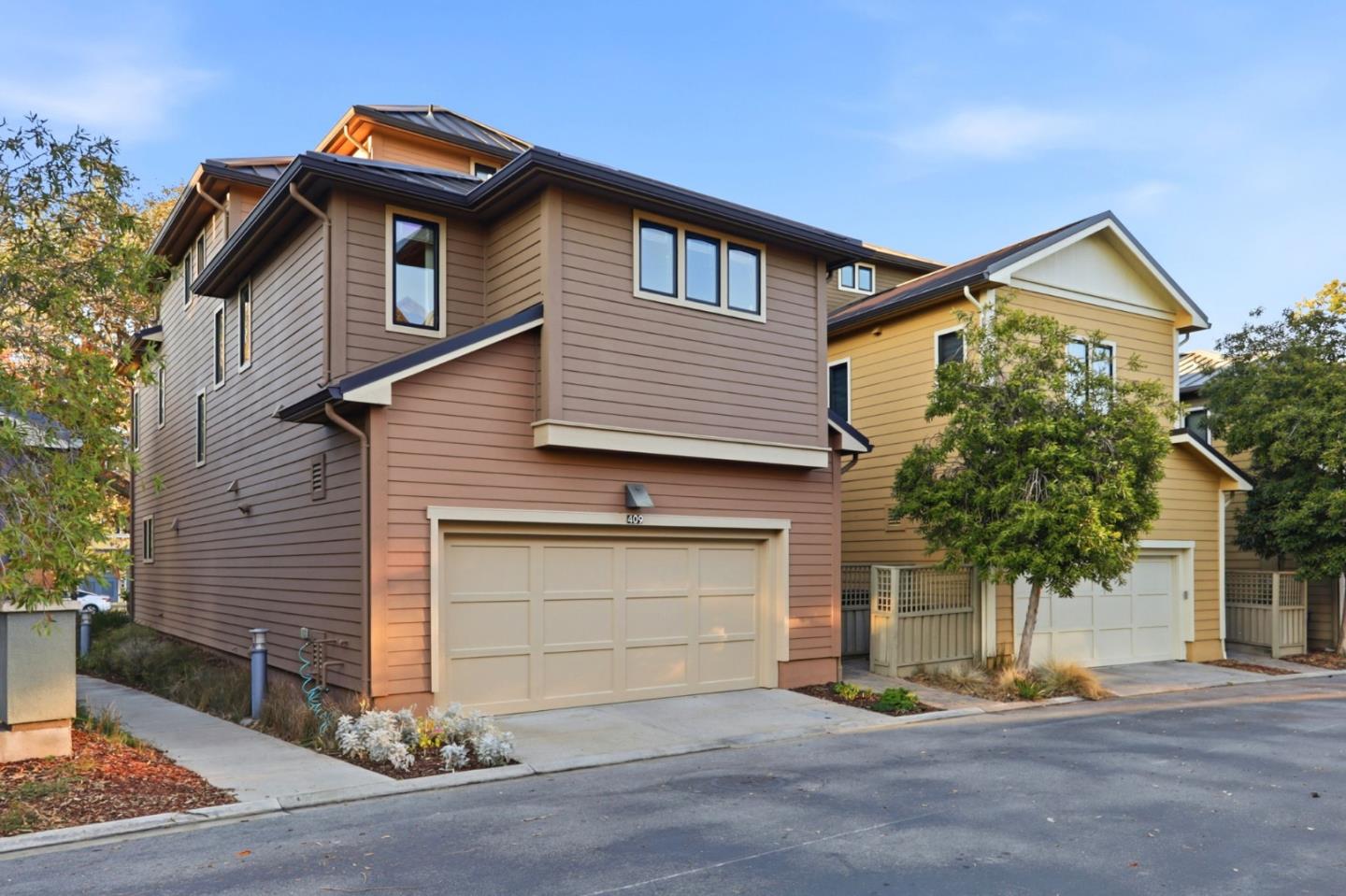 409 Spruce Lane Palo Alto, CA 94306 - Photo 45 of 52 a front view of a house with a yard and garage