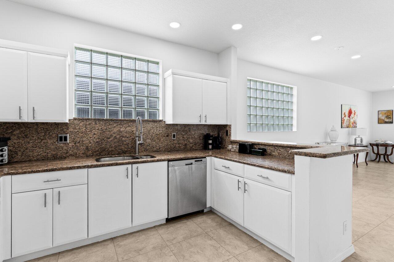 11157 Harbour Springs Circle Boca Raton, FL 33428 - Photo 20 of 68 a kitchen with granite countertop a sink and white cabinets