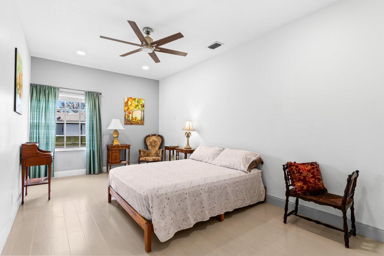 11157 Harbour Springs Circle Boca Raton, FL 33428 - Photo 28 of 68 a bedroom with a bed a desk and chair