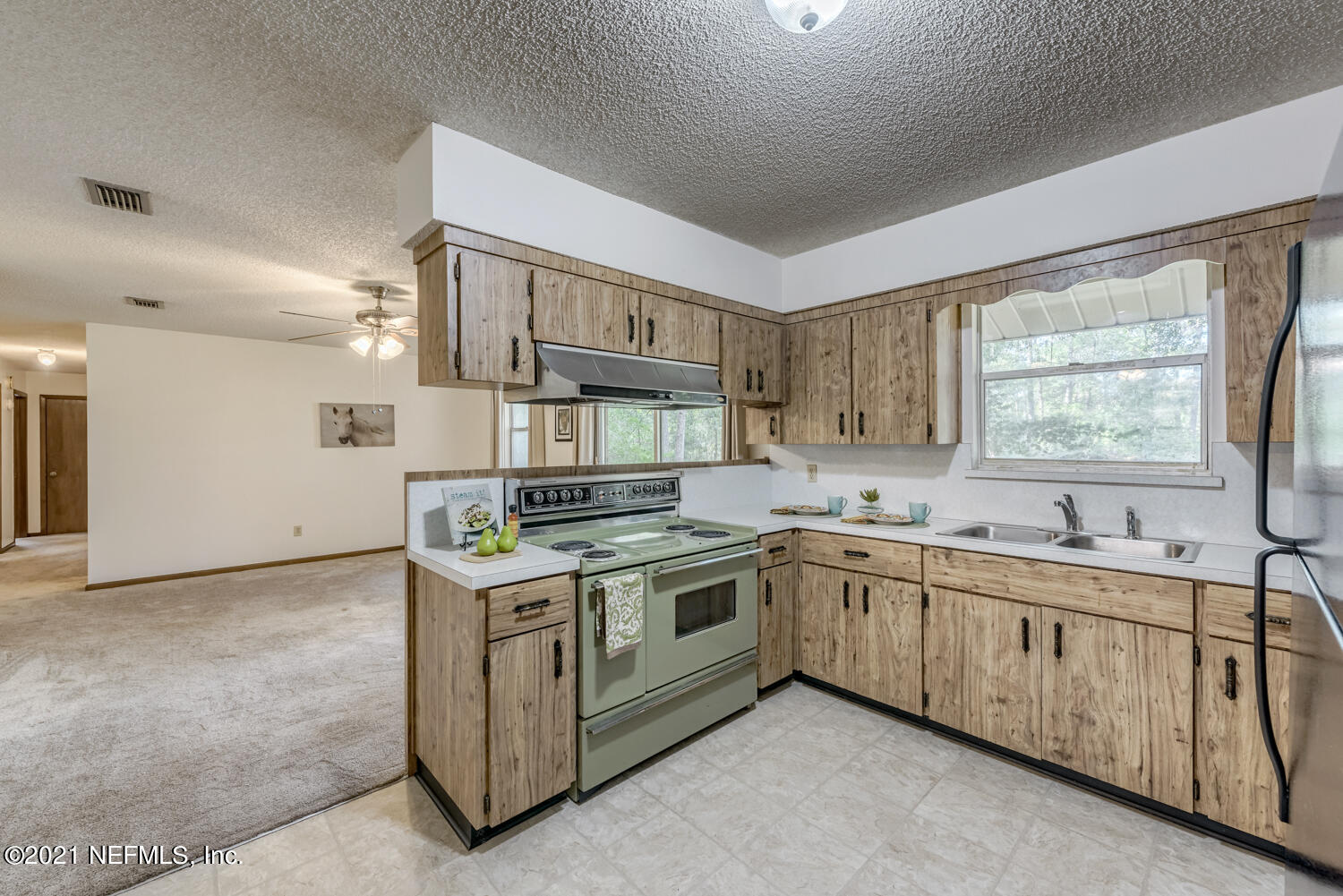 540259 Lem Turner Road Callahan, FL 32011 - Photo 12 of 40 a kitchen with stainless steel appliances granite countertop a stove and a sink