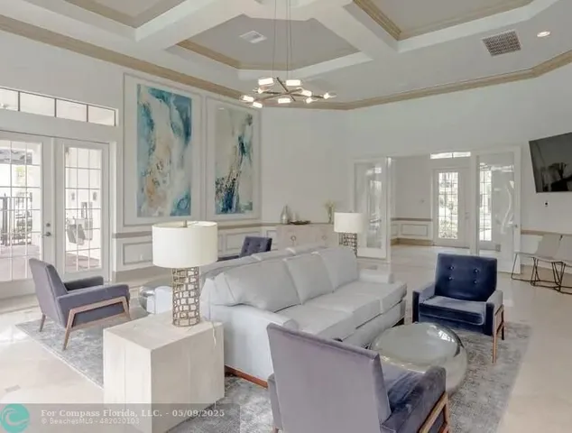 a living room with furniture and a chandelier