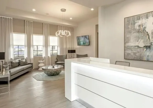 a living room with furniture and large windows