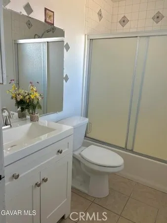 a bathroom with a sink toilet and mirror
