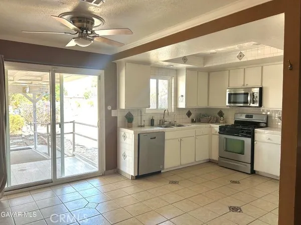 a kitchen with a stove a sink and a refrigerator