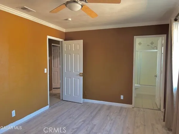 an empty room with wooden floor and closet