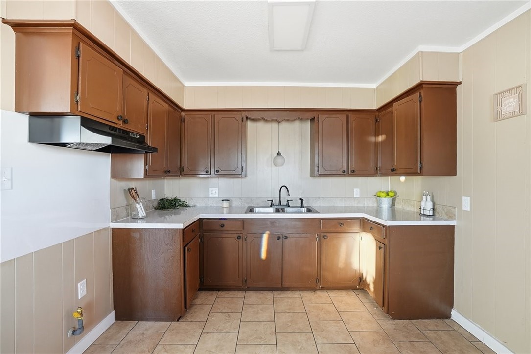 300 Nayer Street Alice, TX 78332 - Photo 7 of 22 a kitchen with a sink a stove and cabinets