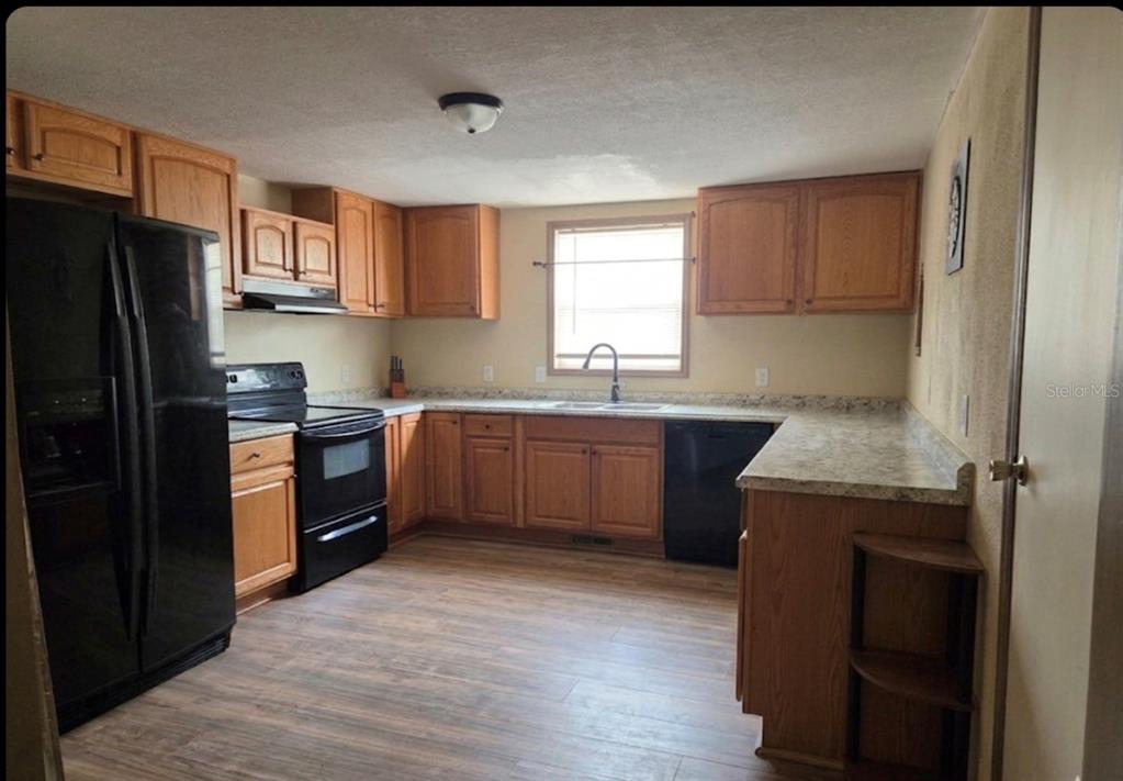 4738 Southwest 166th Court Road Ocala, FL 34481 - Photo 3 of 14 a kitchen with a sink appliances and cabinets