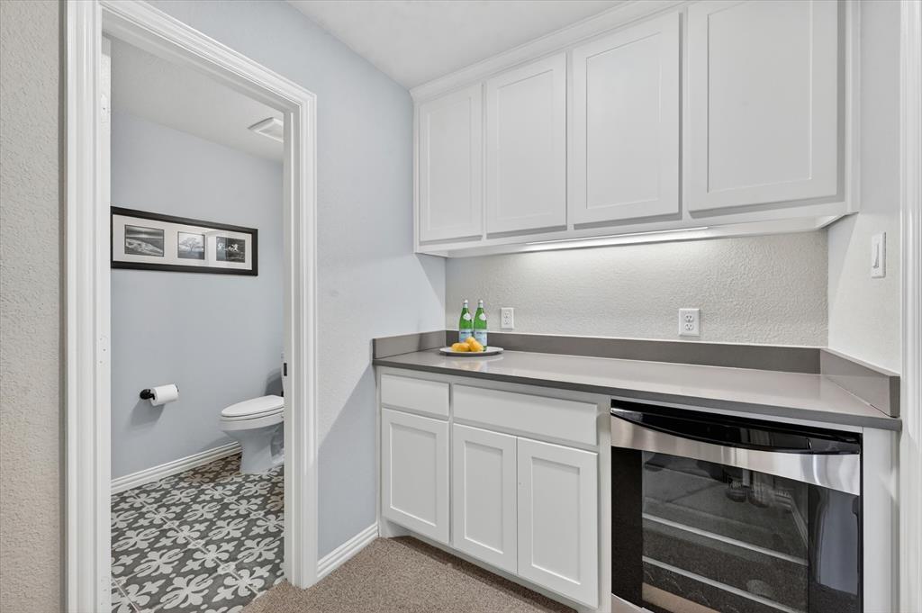 6656 Roughleaf Ridge Road Flower Mound, TX 76226 - Photo 29 of 40 a kitchen with white cabinets and a sink