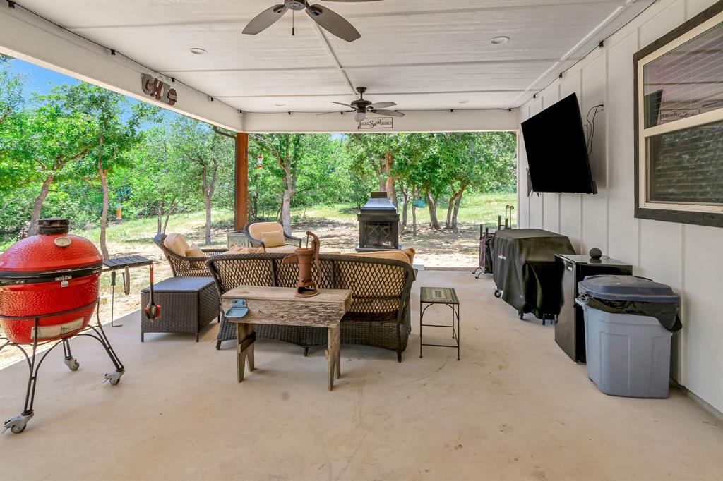 129 Whiskey Rnch Road Runaway Bay, TX 76426 - Photo 33 of 39 a dining room with furniture and a flat screen tv