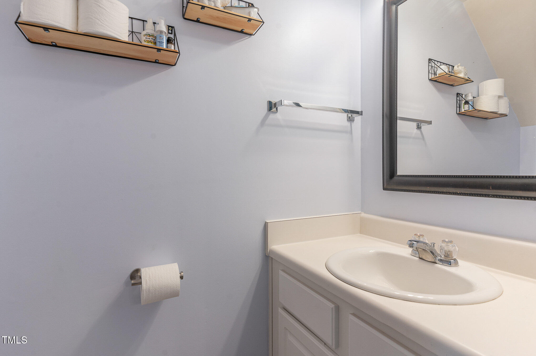 1812 Natalie Brook Way Raleigh, NC 27609 - Photo 14 of 31 a bathroom with a sink and a mirror