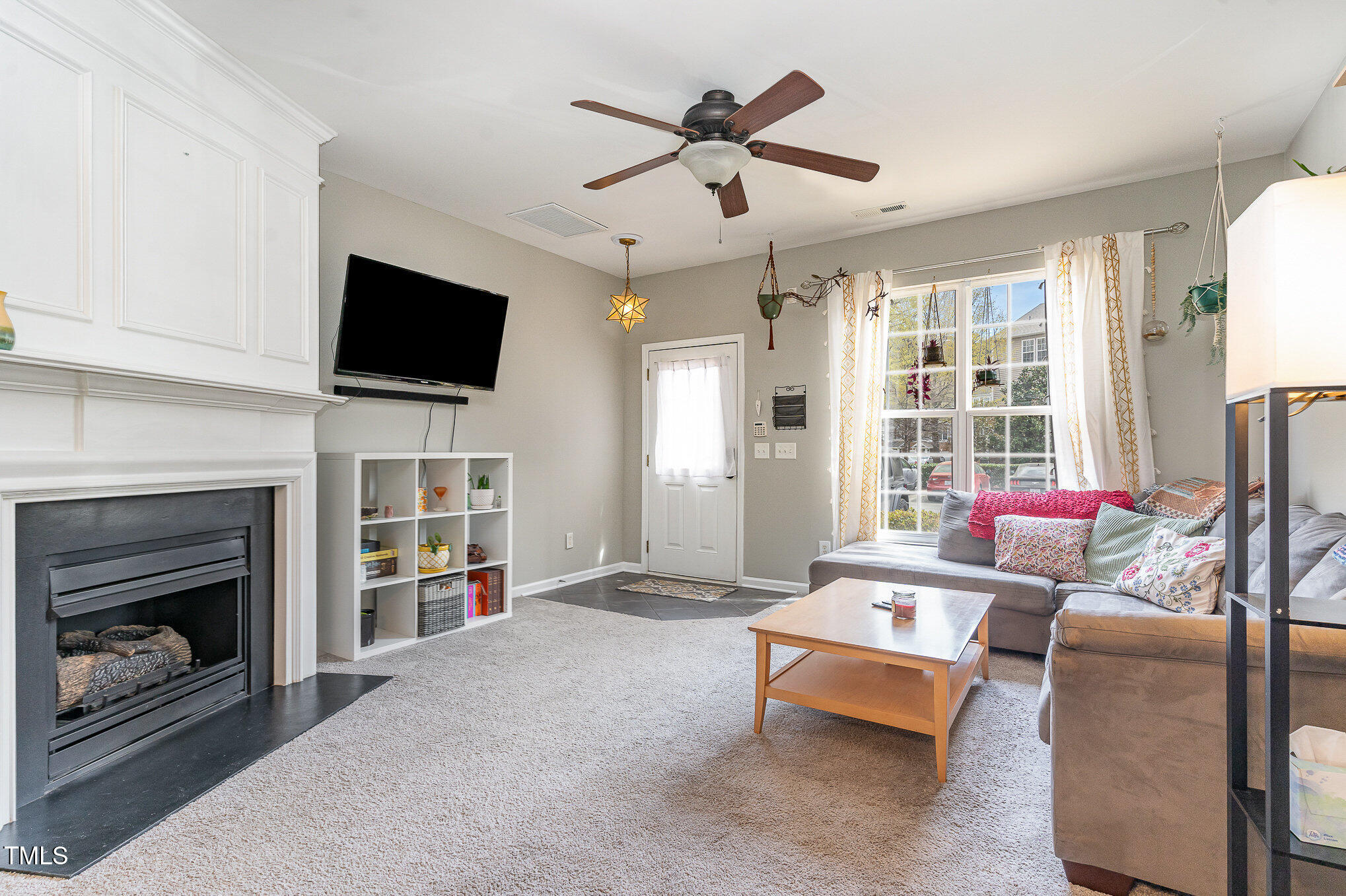 1812 Natalie Brook Way Raleigh, NC 27609 - Photo 7 of 31 a living room with furniture and a fireplace