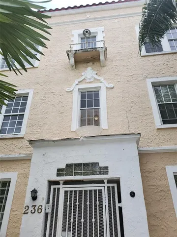 a front view of a house with many windows