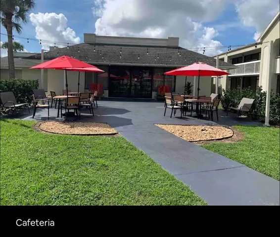 a view of a patio with chairs and a small yard