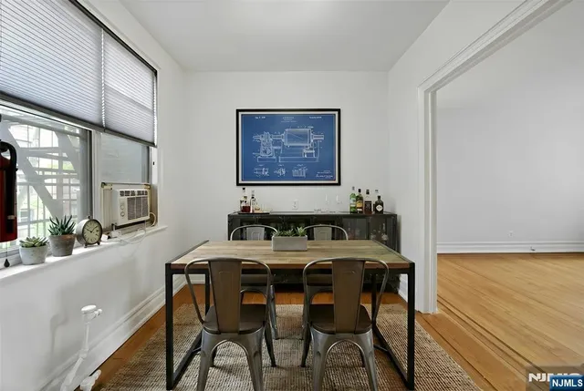 a view of a dining room with furniture and a large window