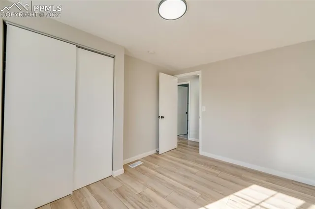 a view of a room with wooden floor